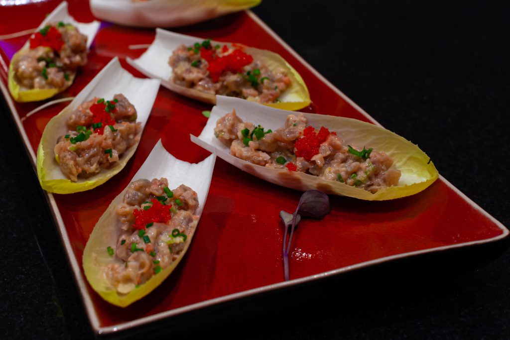 Asian Tuna tartare served as an appetizer on endives.