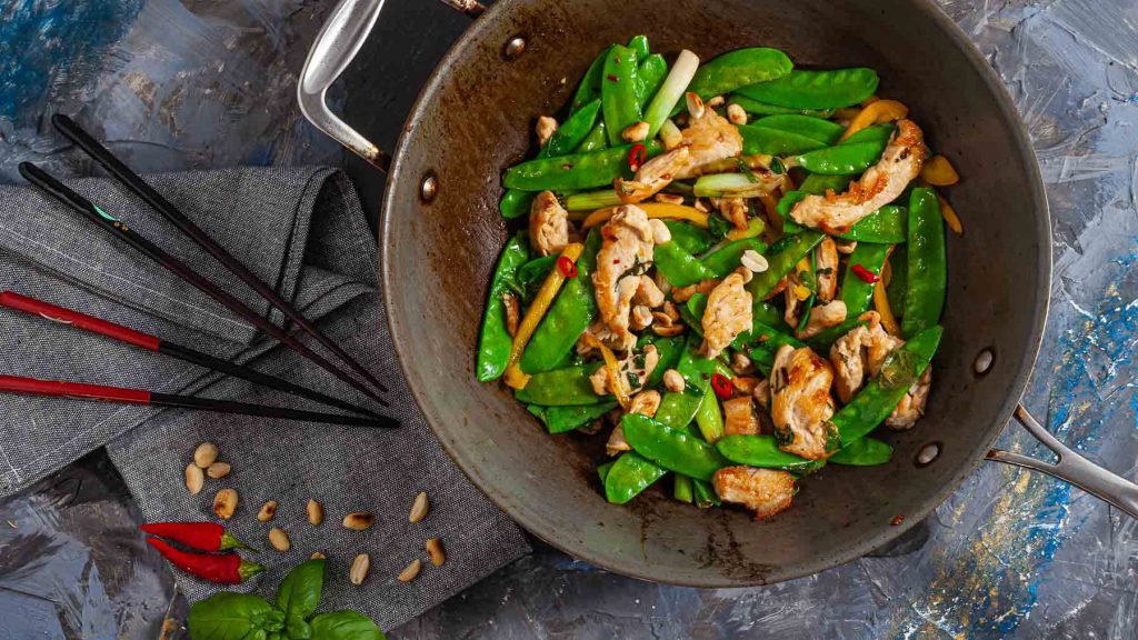 Thai Basil Chicken recipe cooked and in a wok.